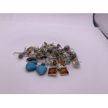 A collection of 15 pairs of silver earrings