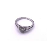 A 9ct white gold and diamond heart design ring. (A