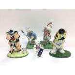 A small collection of golfing animal figures inclu