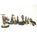 A collection of Country Artist resin birds and cer