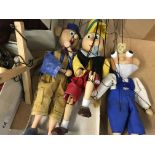 A collection of wooden puppets .