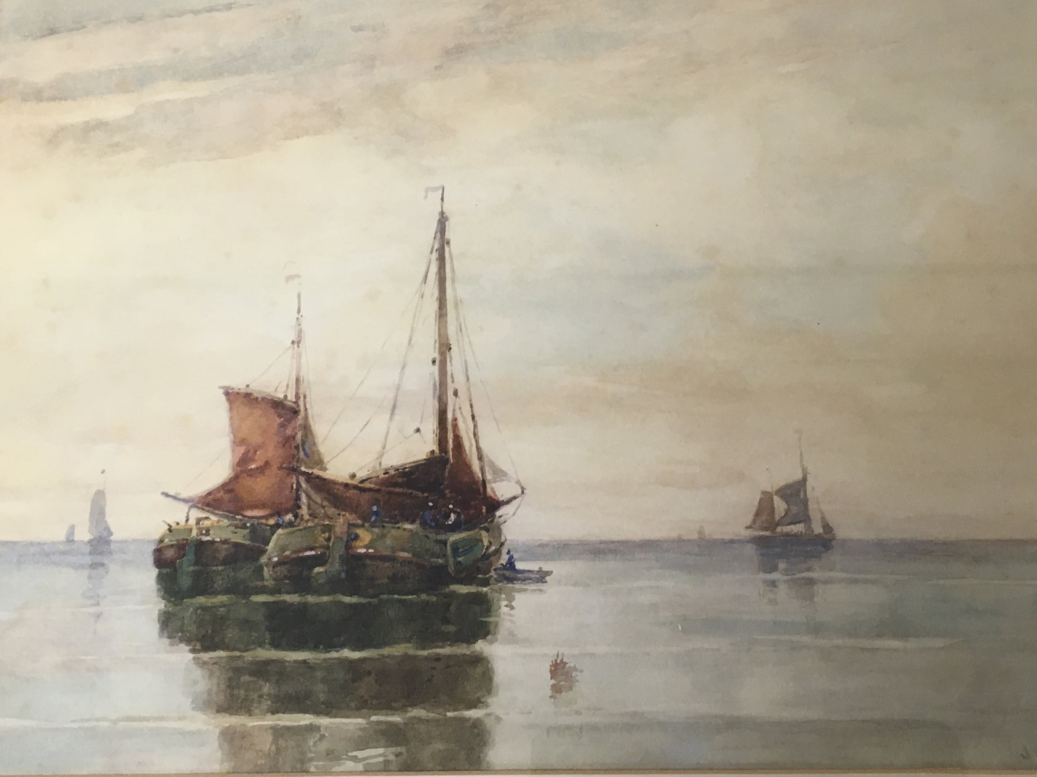 A framed watercolour study of moored sailing barge