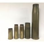 A collection of large brass shells graduating in s
