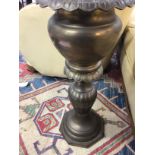 A brass jardiniere with fluted column on shaped ba