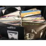 A small suitcase of 7inch singles by various artis
