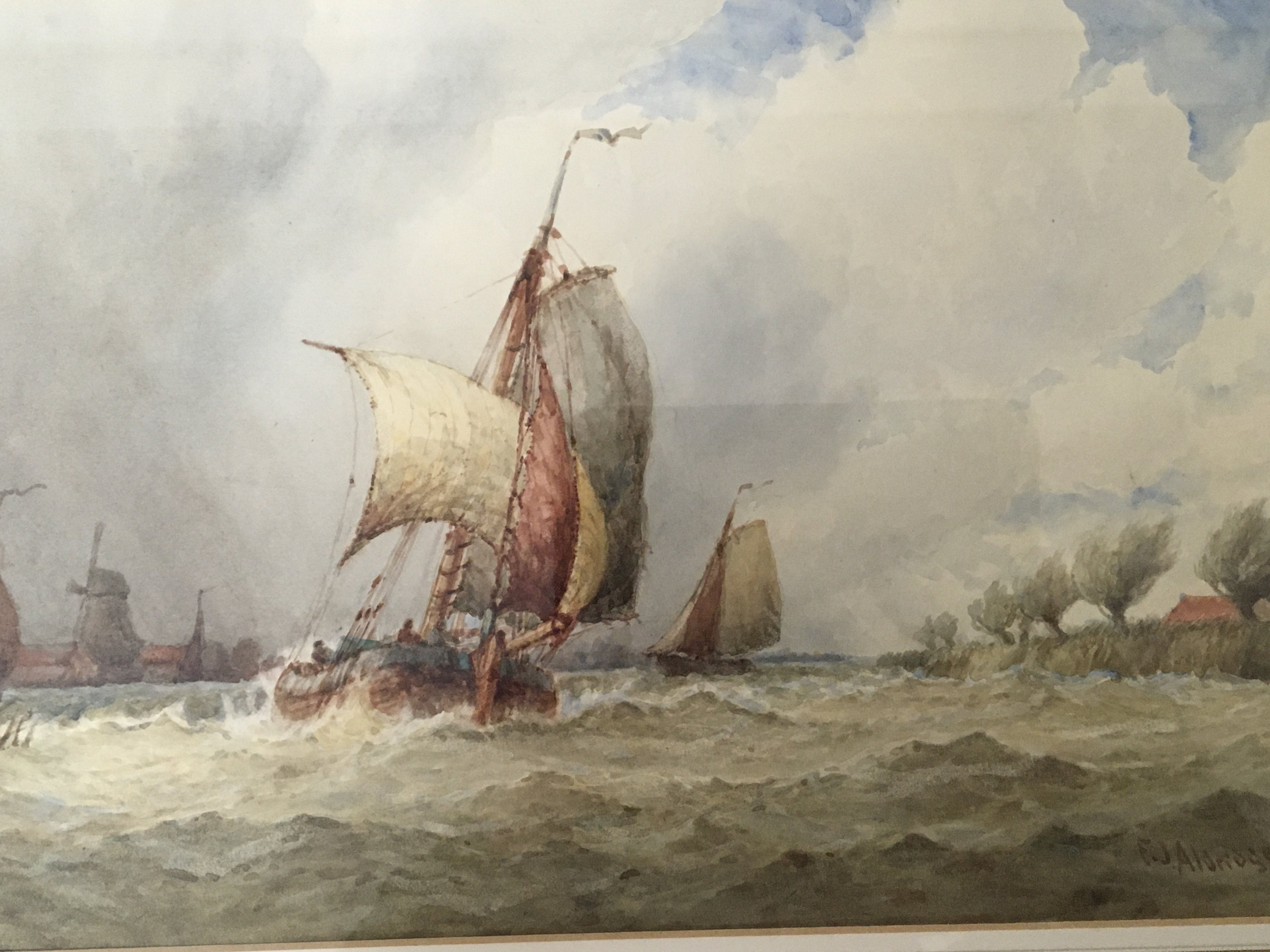 A framed watercolour study of a barge in full sail