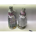 A pair of large 19th Century porcelain figures of ladies maids. 43cm, ( some restoration).