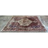 A large Persian hand knotted wool rug, 318 x 203cm, some fading.