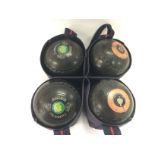 A set of four crown green bowling balls, size 4 H.