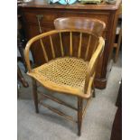 An oak chair with a rush style seat by Johnson, Ta