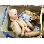 A box of vintage dolls and parts