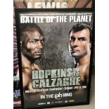 A collection of large framed boxing posters and pi