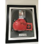 A framed and signed boxing glove Sir Henry Cooper.