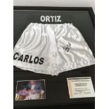 A framed pair of signed boxing shorts Carlos Ortiz