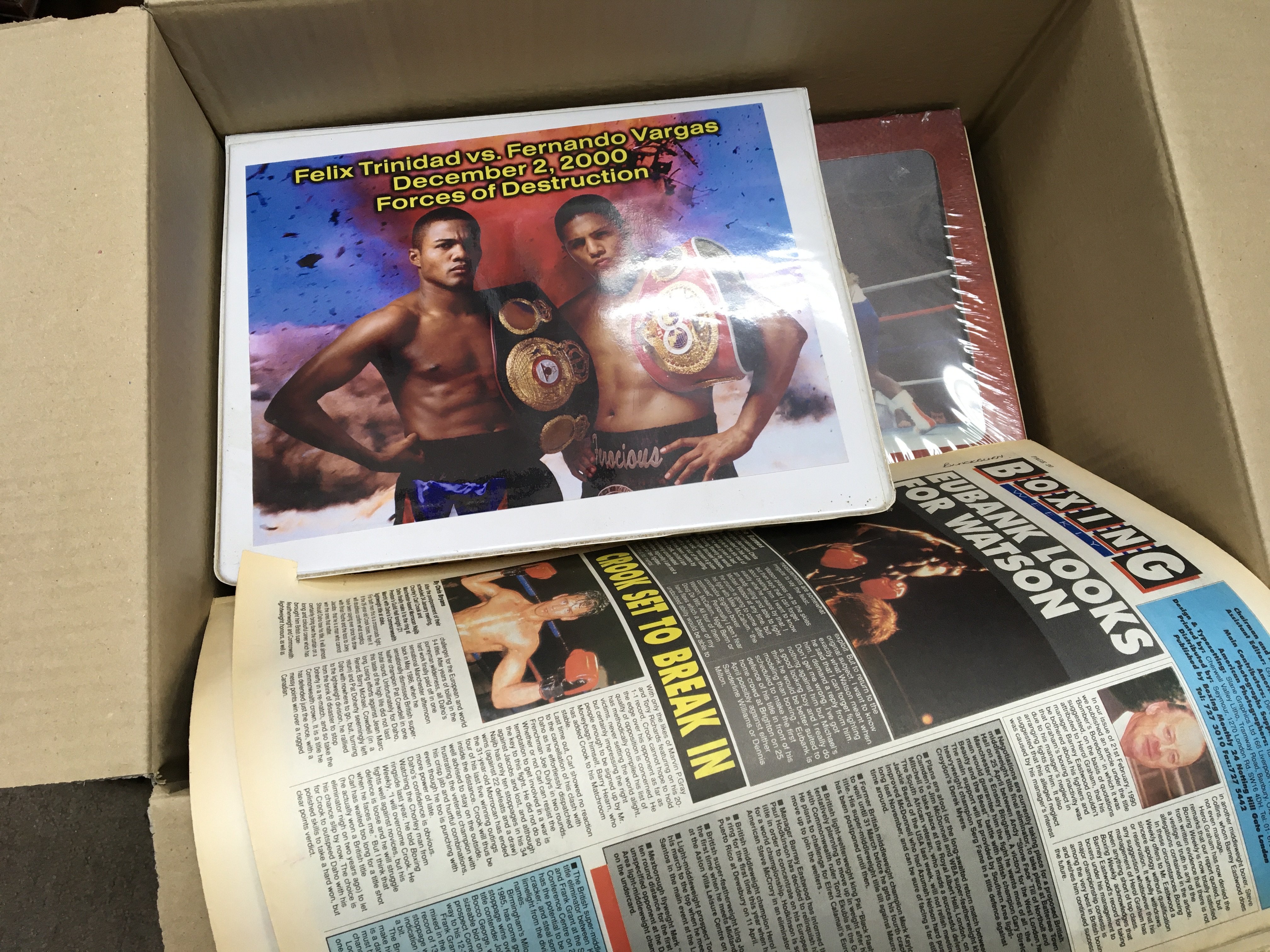 Two boxes containing boxing books scrap books and