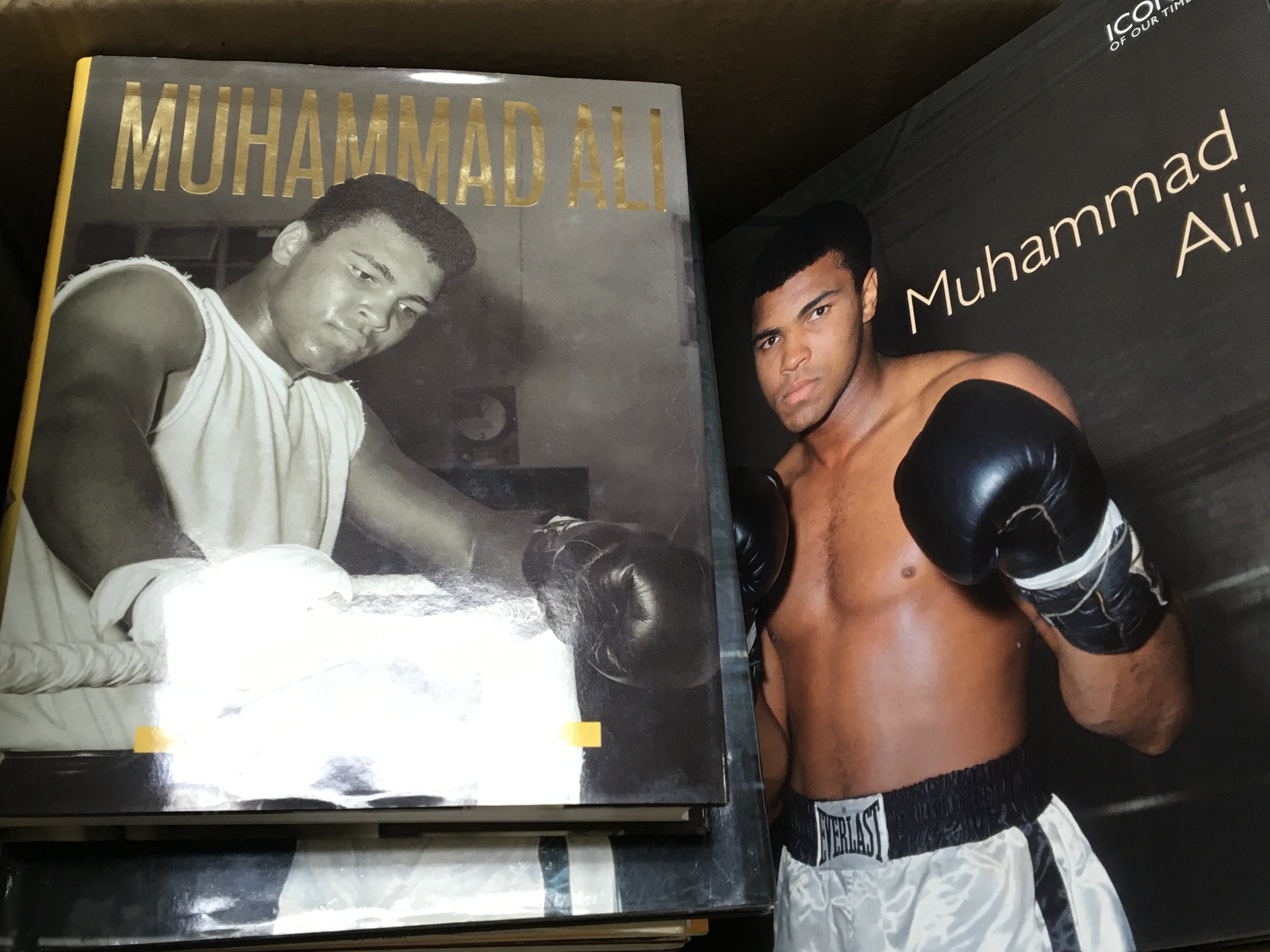 A box containing boxing books predominantly Muhamm