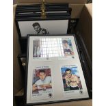 A box containing framed boxing pictures and cards
