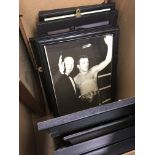 A box containing framed photographs and pictures o