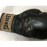 A framed boxing glove Luke Campbell and one other