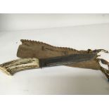 An old hunting knife with a horn handle and steel