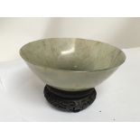 A 19th century Chinese green jade bowl with a carv