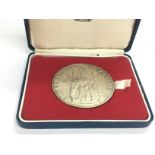 A boxed silver QE2 Coronation medal.