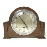 An oak mantle clock by Garrard with chrome key and