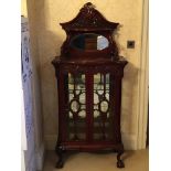 A Mahogany display cabinet with a raised mirrored