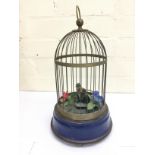 Vintage small brass cage containing a single singi