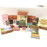 A collection of assorted vintage games, maps, leaf