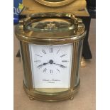 A brass oval carriage clock Charles frodsham the d