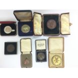A small collection of cased medallions. Shipping c