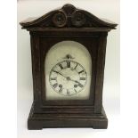An oak mantle clock with a silvered dial, approx h