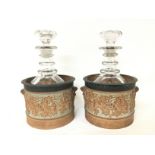 A pair of decanters housed in early 19th century s