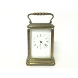 A brass strike repeating carriage clock, with key.
