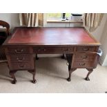 A large mahogany pedestal desk with leather insert