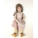 Vintage German doll with a jointed body & a bag of