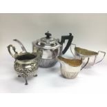 A three piece silver plated tea set and a plated j