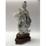 A boxed and carved soap stone oriental figure of a