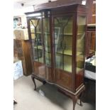 An Edwardian inlaid mahogany display cabinet raise