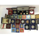 A collection of various cased coins and medallions