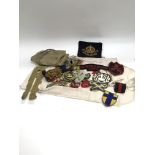 A collection of WW2 medals and badges with a butto