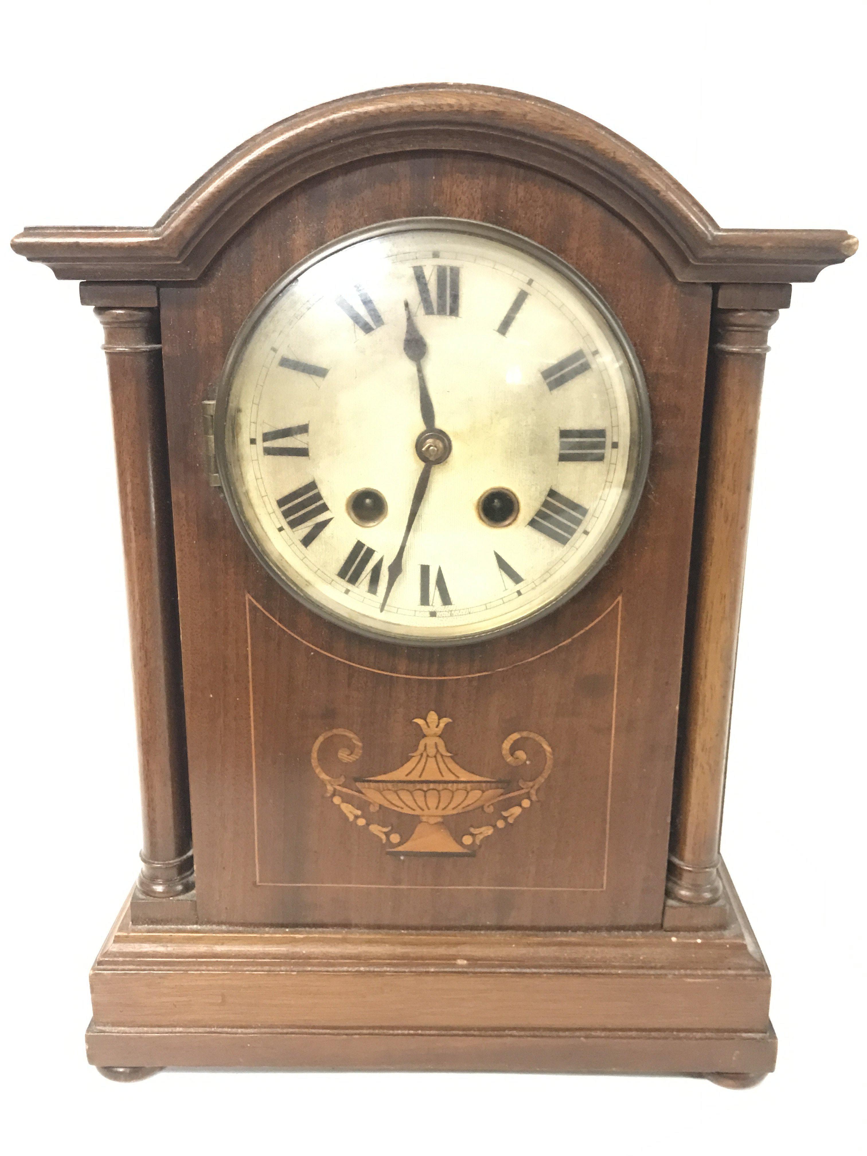 An Edwardian inlaid mahogany mantle clock, with ke