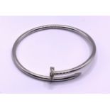 A heavy white gold custom design hinged bangle in