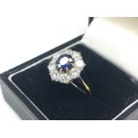 An 18ct Sapphire & Diamond cluster ring, size P/Q.