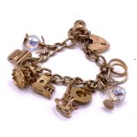 A 9ct gold charm bracelet and attached charms, app