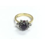 An 18ct gold cluster ring set with diamonds and ru