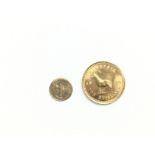 A Rhodesian 1966 ten shilling gold coin and a Mexi