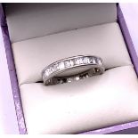 An 18ct white gold and baguette diamond ring, Size