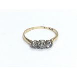 An 18ct gold three stone diamond ring, approx 1.4g